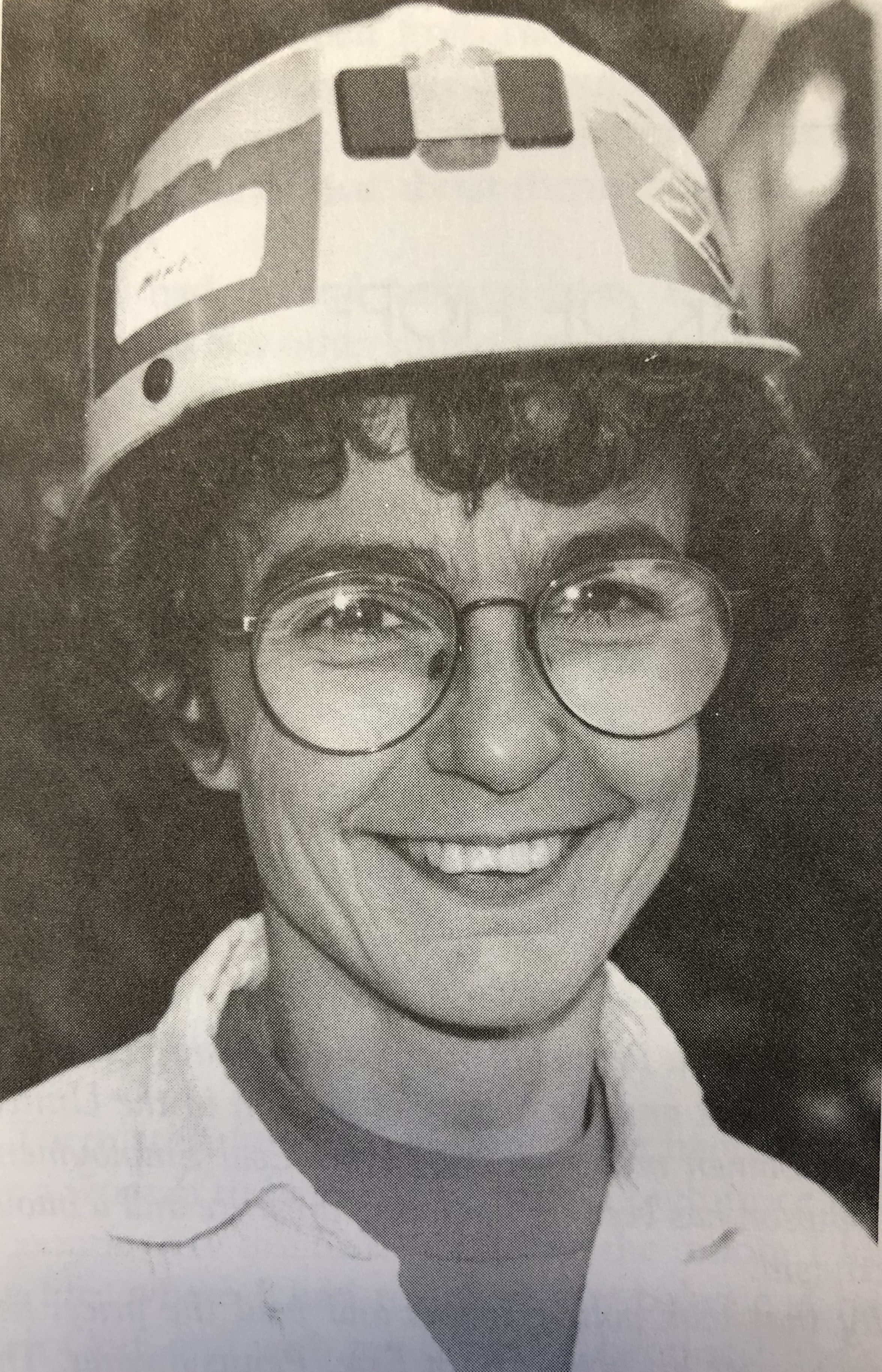 A black and white photo of young Kipp Dawson with glasses and a mining helmet.