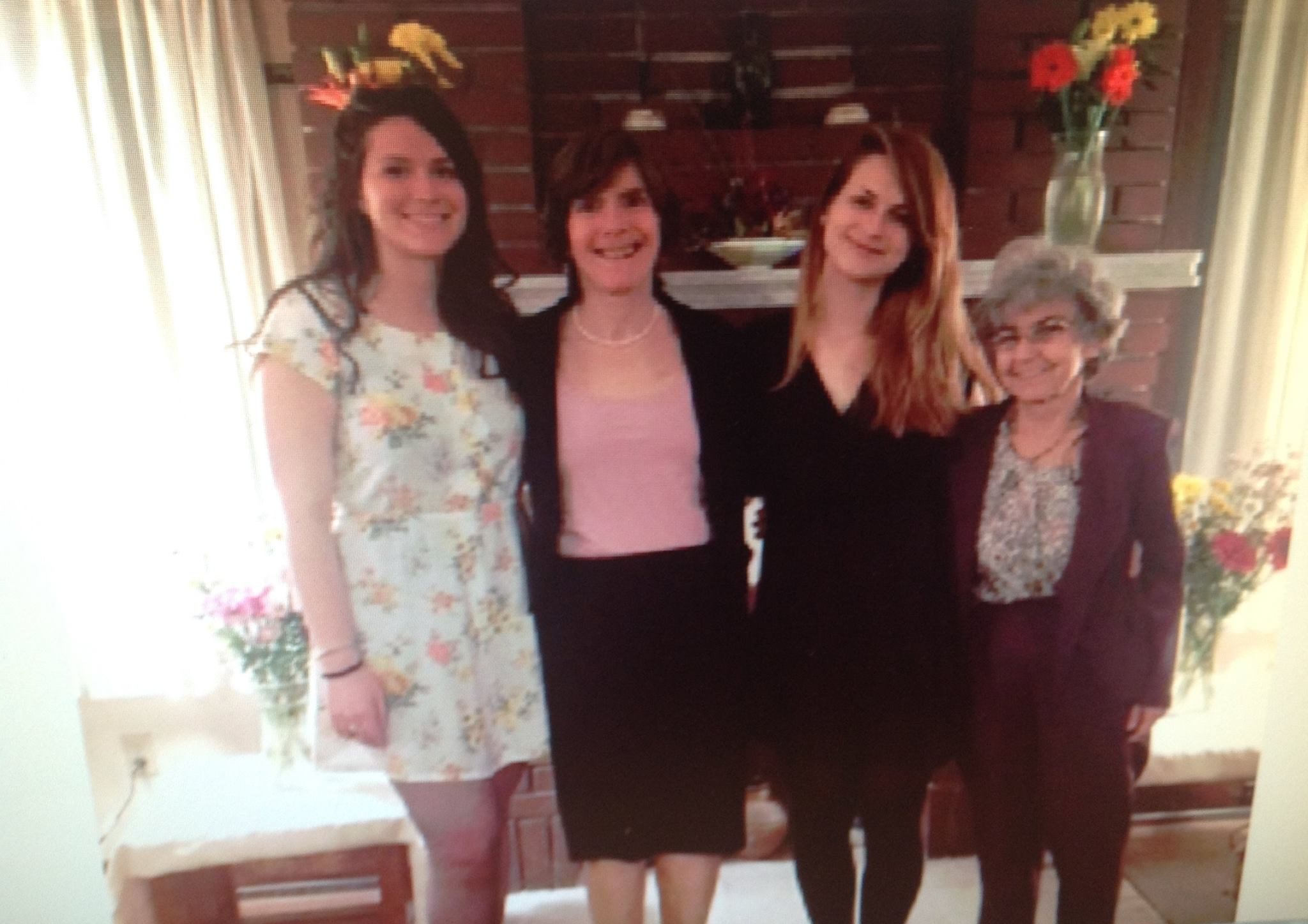 Photo of Kipp Dawson (far left) standing with her daughters and wife.